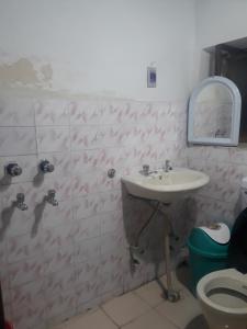 a bathroom with a sink and a toilet at Gonbo Guest House in Leh