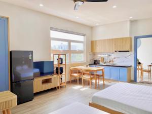 a room with a kitchen and a dining room at Moc Son Apartment - Attractive price for week and month stay in Danang
