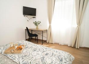 a bedroom with a bed with a tray of fruit on it at Downhill Apartment with a Private Terrace in Kaunas