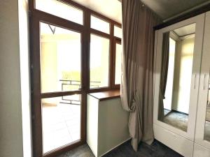 キシナウにあるVilla ACAEMのバルコニーの景色を望む窓付きの客室です。