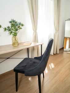 a blue chair sitting in front of a desk at Downhill Apartment with a Private Terrace in Kaunas +35 photos