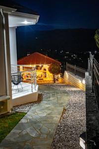 a balcony of a house at night with a view at The Urban Escape in Ioannina