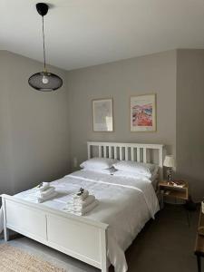 a bedroom with a white bed with towels on it at The Urban Escape in Ioannina