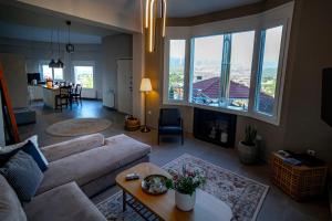 a living room with a couch and a large window at The Urban Escape in Ioannina