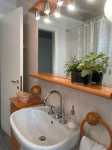 a bathroom with a sink and a mirror at La casa in collina in Caprino Veronese +54 photos
