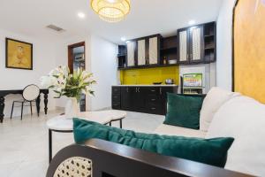 a living room with a white couch and a table at Sun Clover Boutique Hotel in Hanoi