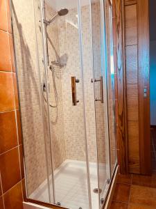 a shower with a glass enclosure in a bathroom at Hotel Pop in Cala Gonone