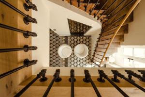 a room with a wooden floor and a spiral staircase at Clos des Dames de Lancharre - La Maison Des Vignes in Chapaize