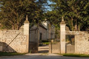 a brick fence with a gate and a stone wall at Clos des Dames de Lancharre - La Maison Des Vignes in Chapaize