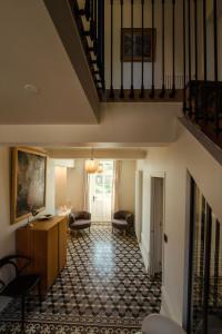 a hallway with a staircase and a living room at Clos des Dames de Lancharre - La Maison Des Vignes in Chapaize