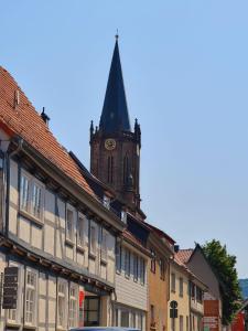 ein Gebäude mit einem Uhrturm und einer Kirche in der Unterkunft Neustadt-Blick in Heilbad Heiligenstadt