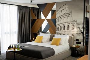 a bedroom with a large bed with a drawing on the wall at MM Boutique Hotel in Burgas