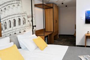 a bedroom with a bed with a picture of the leaning tower at MM Boutique Hotel in Burgas