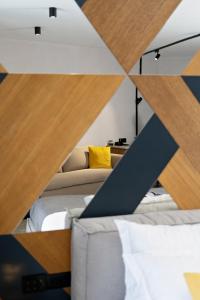 a room with two beds and a mirror at MM Boutique Hotel in Burgas
