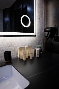 a bathroom counter with a sink and a picture at MM Boutique Hotel in Burgas