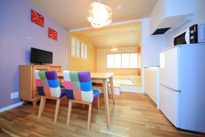 a kitchen with a table and chairs and a refrigerator at 柏・二条1（Haku Nijo1） in Kyoto