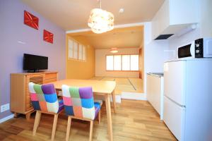 a kitchen and dining room with a table and a refrigerator at 柏・二条1（Haku Nijo1） in Kyoto