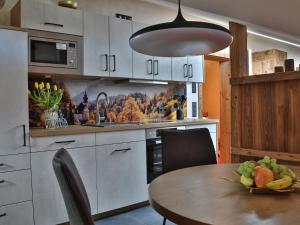 a kitchen with a table with a bowl of fruit on it at Ferienwohnungen Bergsonne und Gipfelsonne in Bad Reichenhall