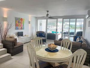 a living room with a table and chairs at Villa 238A Jolly Harbour in Jolly Harbour