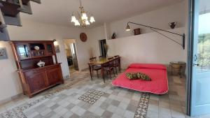 a bedroom with a red bed and a table at Villa Fiorentina e la Costa dei Trabocchi in Marina San Vito +46 photos