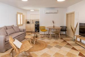 a living room with a couch and a table at Vacay Suites in Firostefani