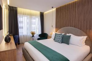 Voodi või voodid majutusasutuse Le M Hôtel toas