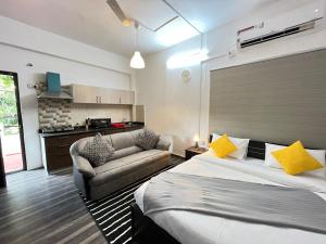 a hotel room with a bed and a couch at BedChambers Serviced Apartments in Hyderabad