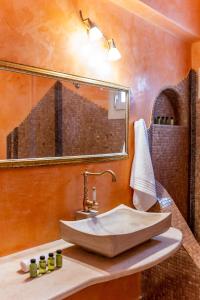 a bathroom with a sink and a mirror at Vacay Suites in Firostefani