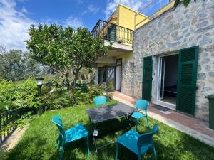 a patio with a table and chairs in a yard at BikeandClimb B&B in Finale Ligure