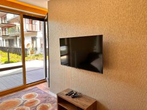 a flat screen tv hanging on a wall at Nadmotławie Apartament with RENT Motor Boat in Gdańsk