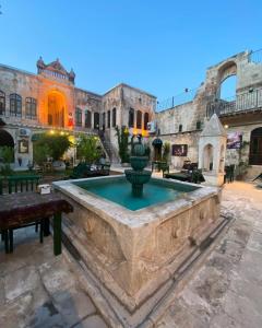 a fountain in the courtyard of a building at HANEHAN in Urfa +42 photos