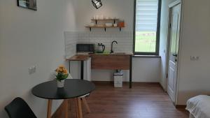 a small kitchen with a table and a sink at Terkhena in Stepantsminda