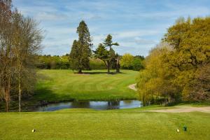 a view of a golf course with a pond at Ufford Park Resort in Woodbridge