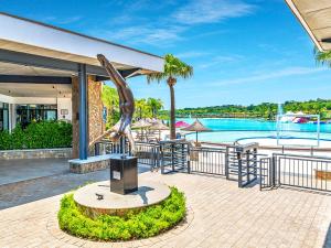 a statue in front of a swimming pool at 6 The Blyde Crystal Clear Lagoon 2 Bedroom Apartment in Pretoria