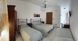 En eller flere senge i et værelse på Agriturismo Torre del Cardo