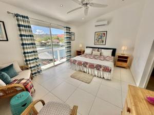 a bedroom with a bed and a view of the water at Villa 218E Jolly Harbour in Jolly Harbour