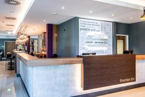 a bar in a restaurant with a large screen at Premier Inn Heidelberg City Centre in Heidelberg