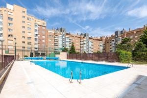 an empty swimming pool in front of some buildings at Cituspace Las Tablas - Grañón in Madrid