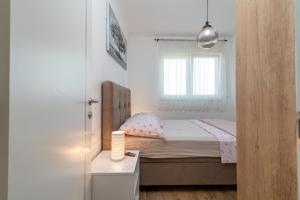 Postel nebo postele na pokoji v ubytování Apartments Angelus