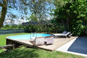 a deck with two chairs and a swimming pool at Villa Pontecorvo with Swimming Pool in Sant'Agnello