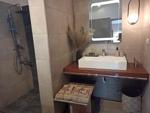 a bathroom with a sink and a mirror at achlia beach apartments 1 in Ierapetra