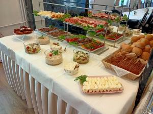 a buffet of food on a white table at Iskra in Radom