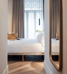 a bedroom with a bed in front of a window at Oliveira Rooms in Valencia