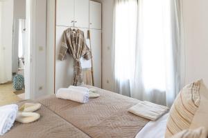 a bedroom with a bed with towels on it at Tethys 3 by Cretan Pnoe Adults Only in Kolymvari