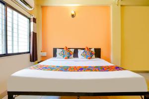 Llit o llits en una habitació de FabExpress Ravikiran
