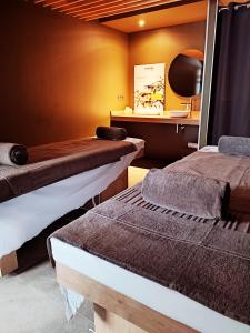 a room with two beds and a table in it at Belaroïa Montpellier Centre Saint Roch in Montpellier