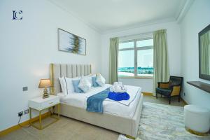a bedroom with a large bed and a window at Palm Jumeirah's Spectacular Ocean-View Apartment - NBT in Dubai