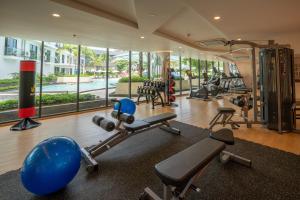 a gym with a lot of exercise equipment in a building at Wyndham La Vita Rawai Phuket in Rawai Beach