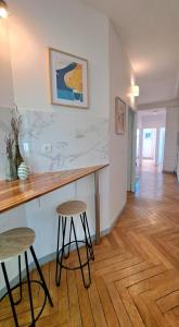 a kitchen with a counter and stools in a room at Les Matelots Rouen Centre by MyFrenchPAT in Rouen