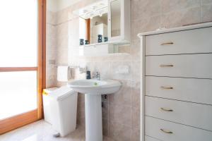 a bathroom with a sink and a toilet at Casa Vacanza Germano in Pachino +41 photos